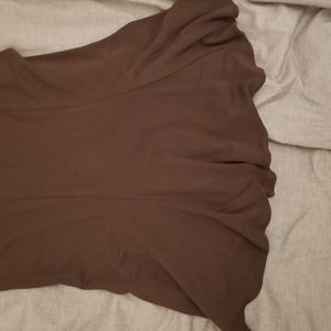 Tight brown skirt that flares.